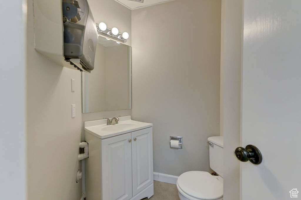 Half bathroom featuring toilet and vanity