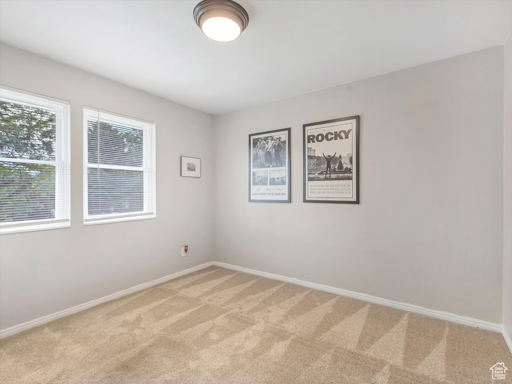 Spare room with light colored carpet and baseboards