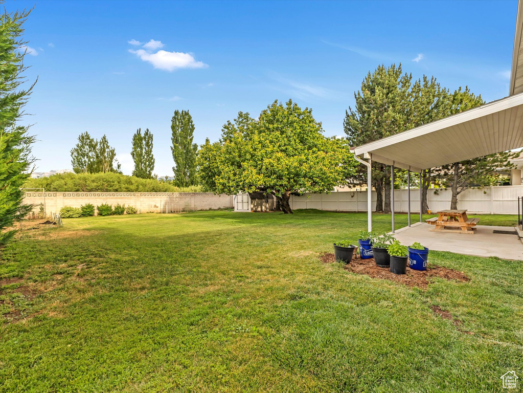 Fenced backyard with a patio