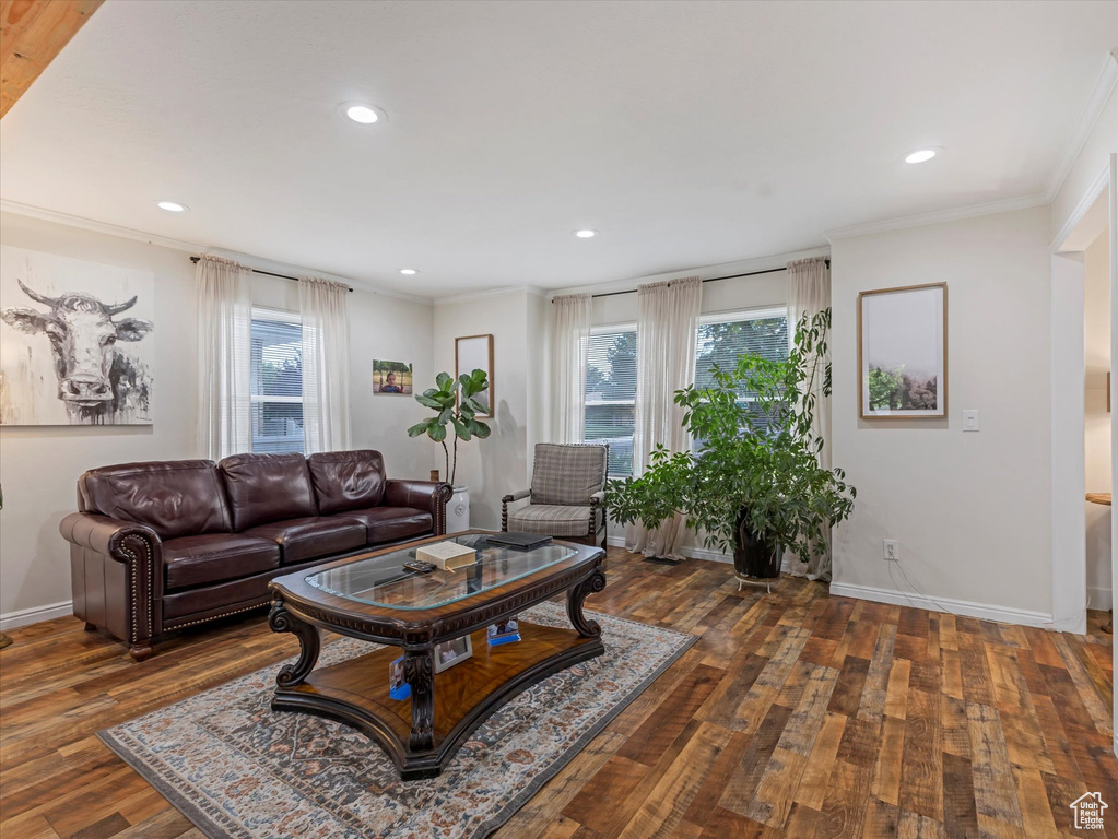 Living area with healthy amount of natural light, ornamental molding, hardwood / wood-style floors, and recessed lighting