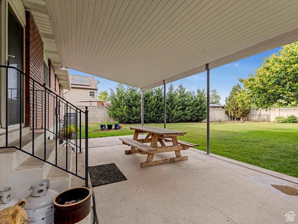 Fenced backyard with a patio area and outdoor dining area