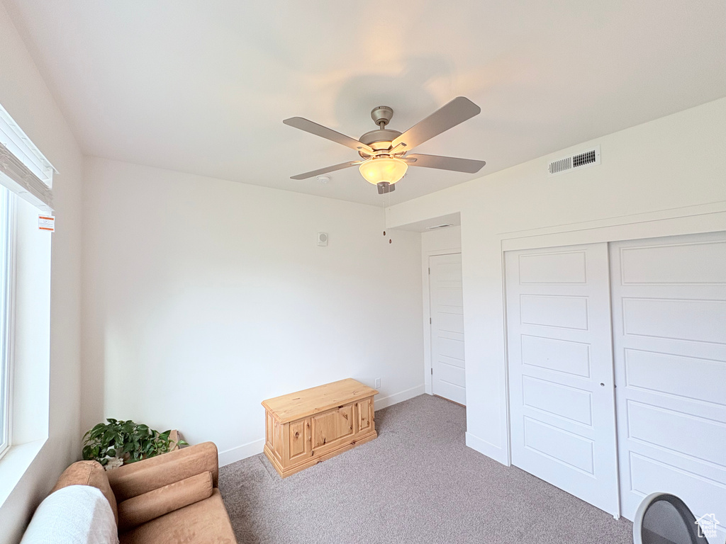 Sitting room with carpet flooring and ceiling fan