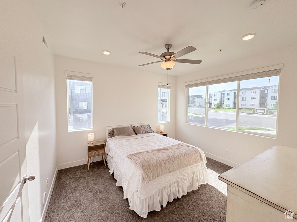 Bedroom featuring dark colored carpet, recessed lighting, and a ceiling fan