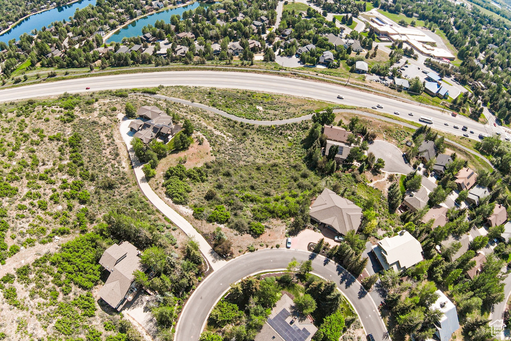 Aerial view of residential area featuring a nearby body of water