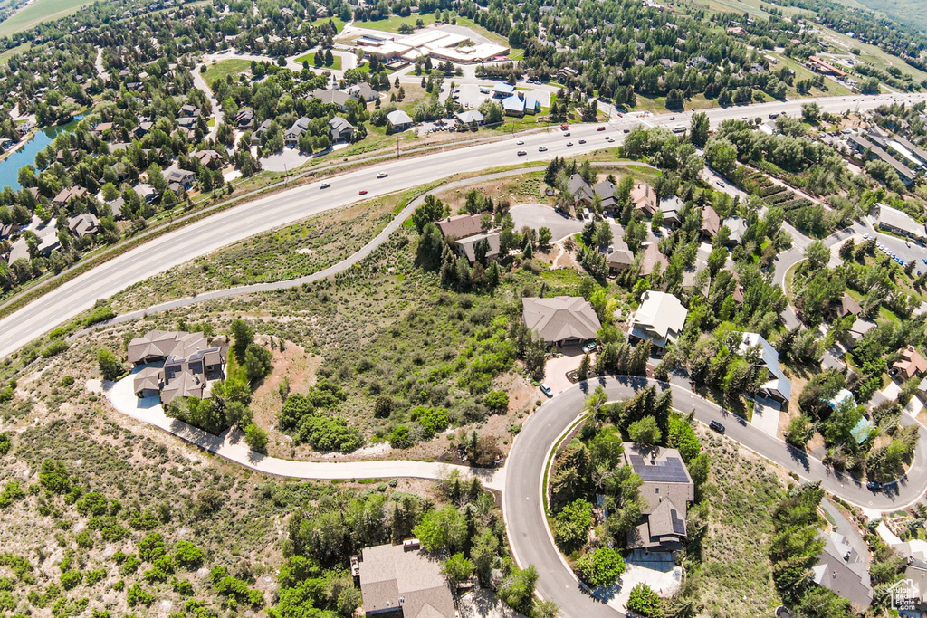 Aerial view of residential area featuring a nearby body of water and a main thoroughfare