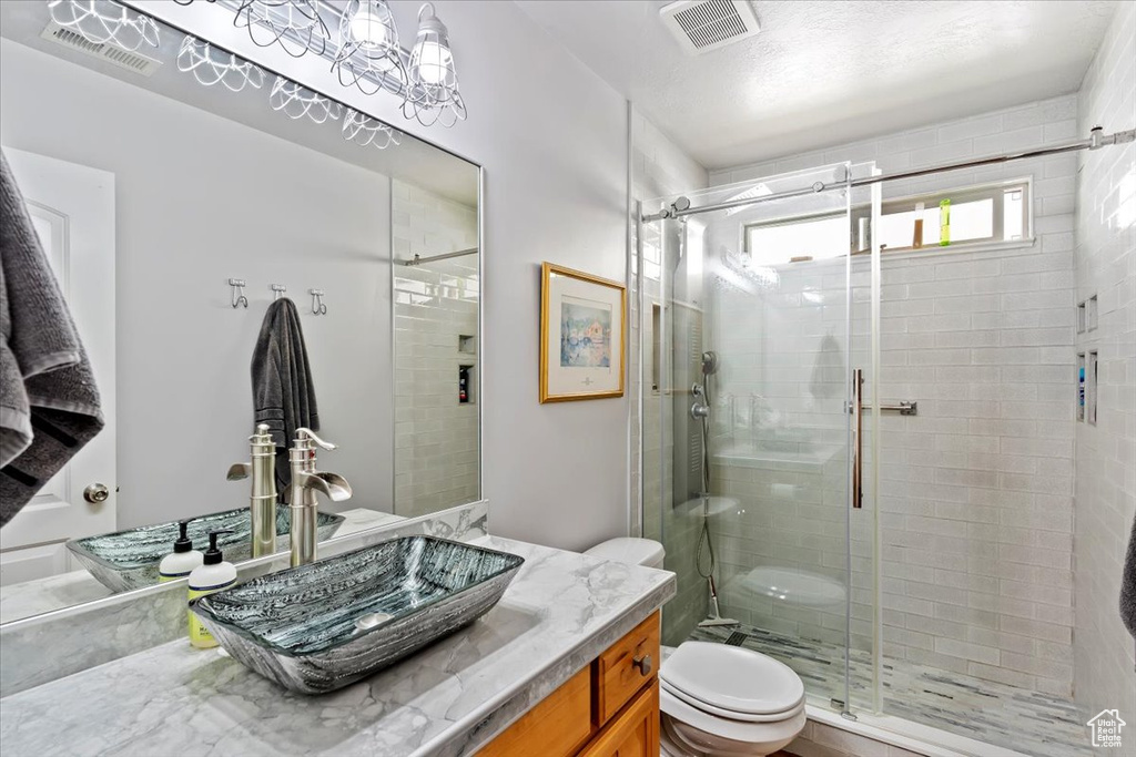 Full bath with a stall shower and vanity