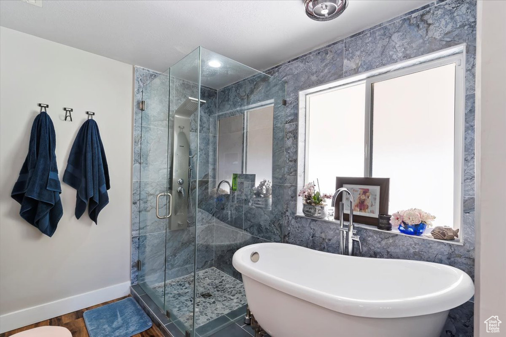Bathroom featuring a freestanding tub and a stall shower