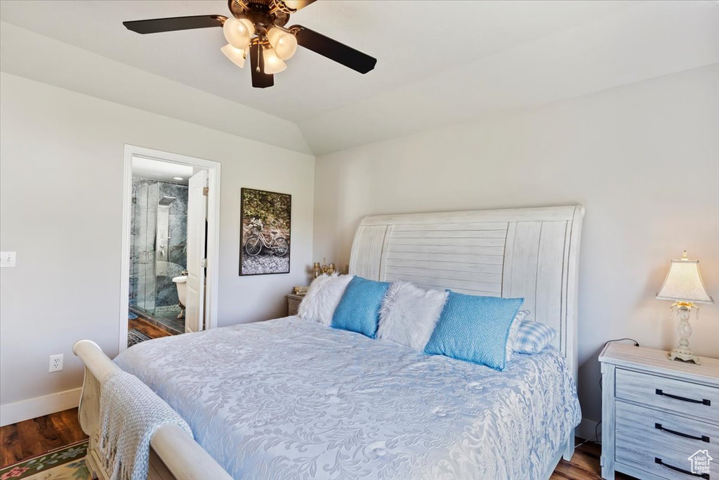 Bedroom with wood finished floors, ceiling fan, lofted ceiling, and connected bathroom