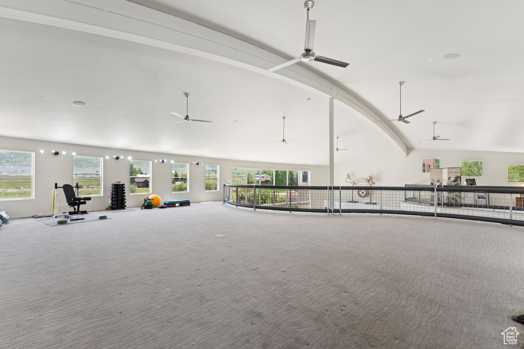 Interior space featuring lofted ceiling, ceiling fan, and healthy amount of natural light