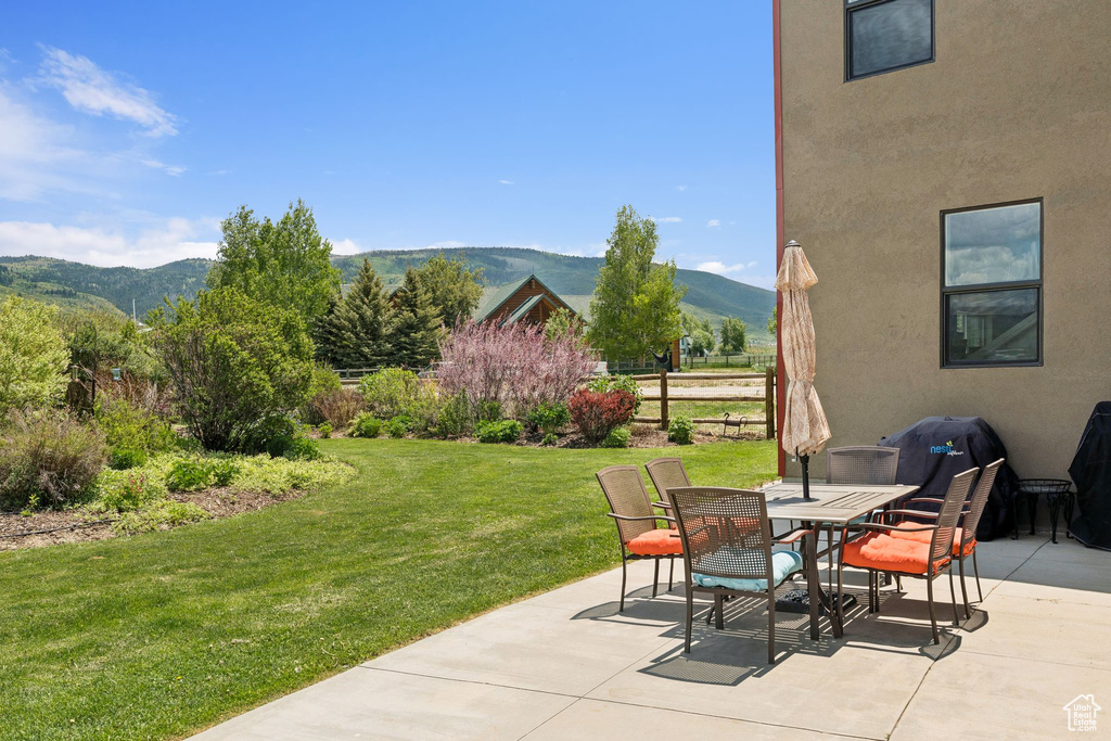 View of patio / terrace with a mountain view and outdoor dining area