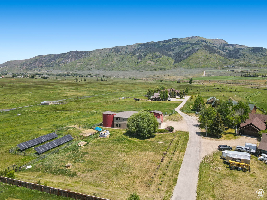 Aerial view of sparsely populated area with a mountain backdrop and agricultural land