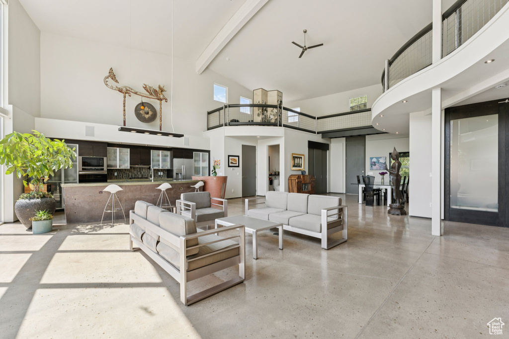 Living area with a towering ceiling and beam ceiling