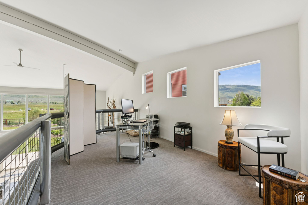 Home office featuring carpet flooring, a ceiling fan, and baseboards