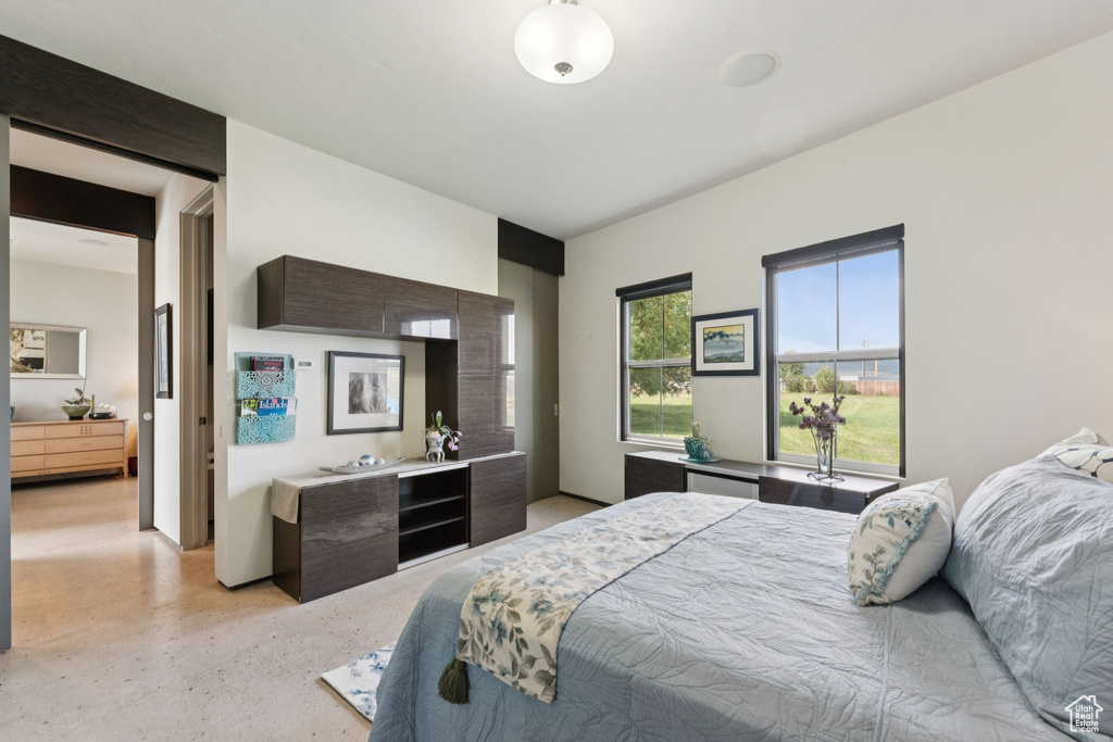 Bedroom featuring dark aggregate flooring