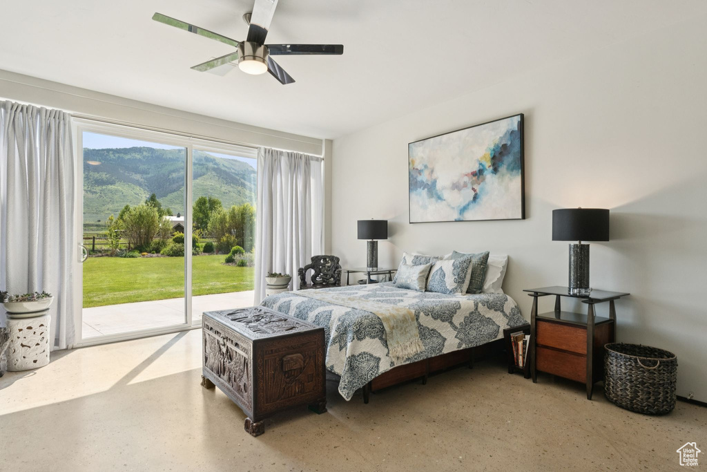 Bedroom with access to exterior, a mountain view, and ceiling fan