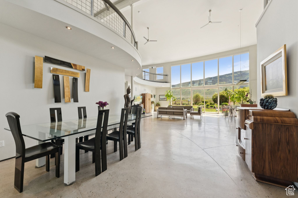 Dining area with a high ceiling, finished concrete floors, and a mountain view