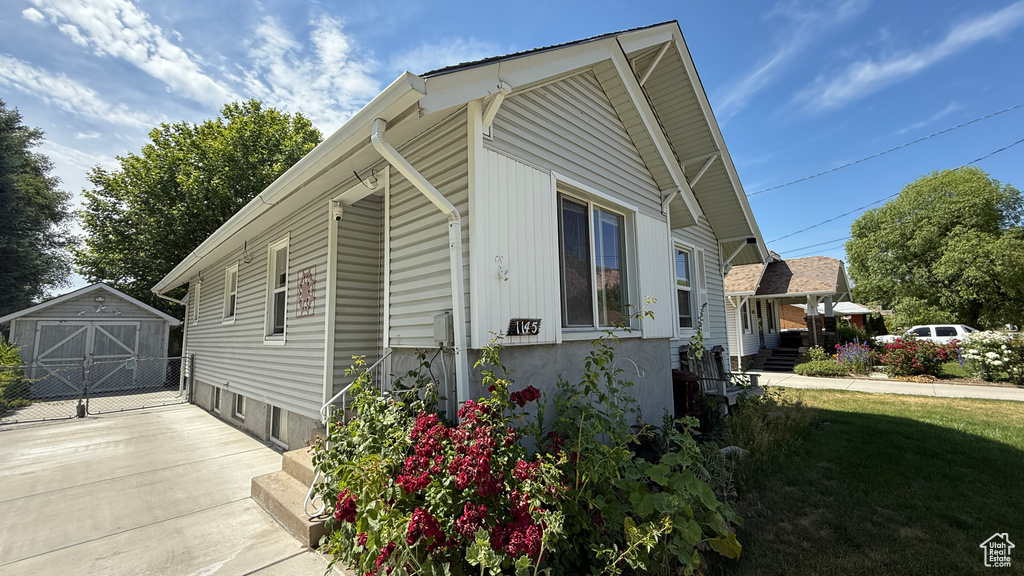 View of property exterior featuring an outbuilding
