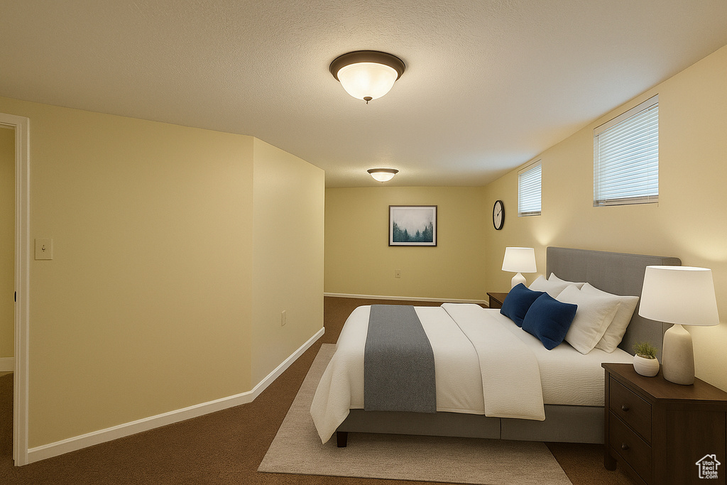 Bedroom featuring baseboards and dark carpet