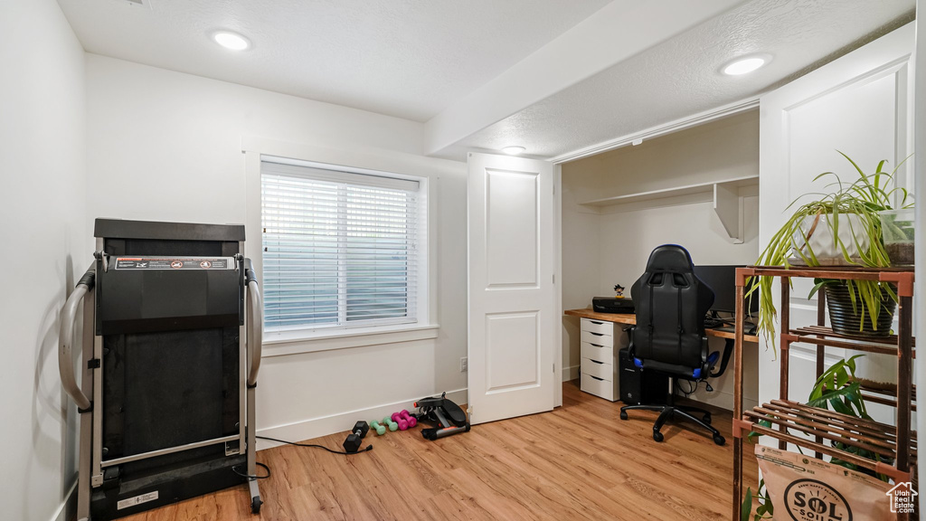Office space with light wood-type flooring, baseboards, and recessed lighting