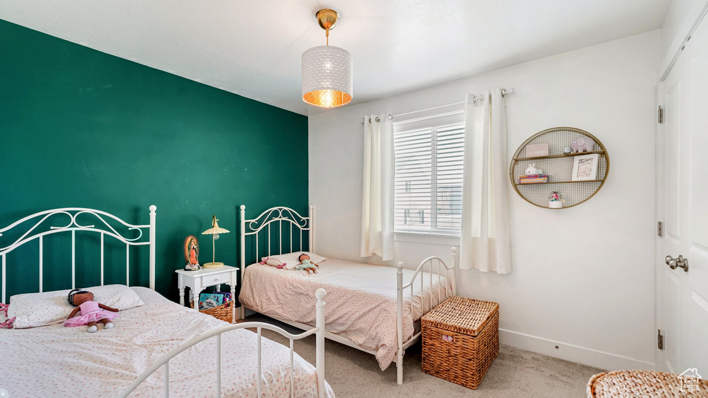 Carpeted bedroom featuring baseboards