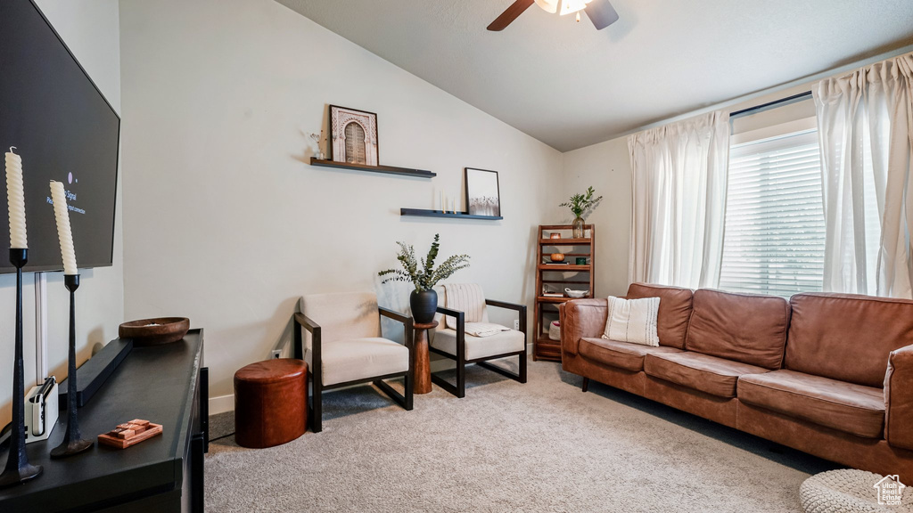 Living room with carpet, vaulted ceiling, and ceiling fan