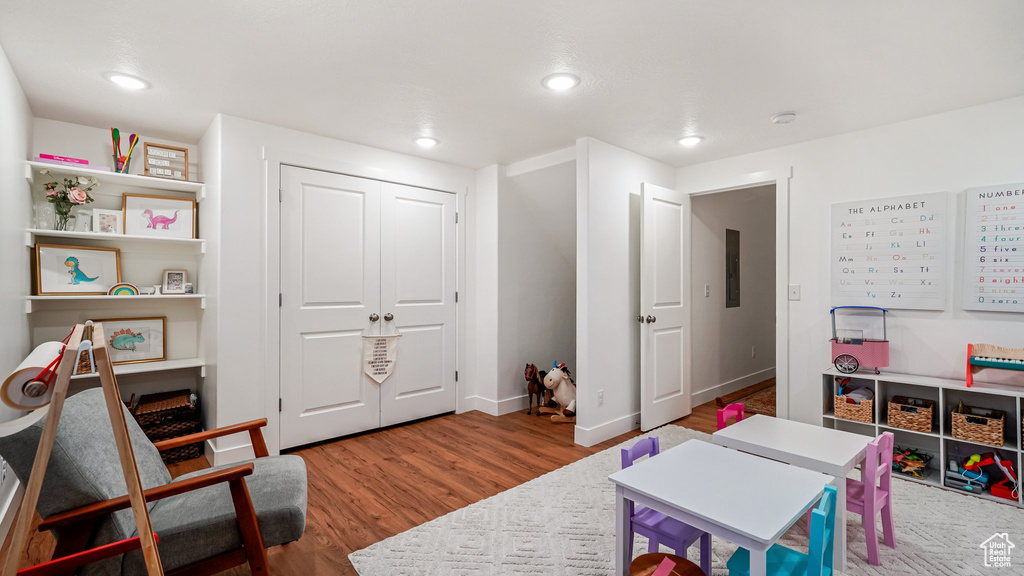Game room featuring wood finished floors, recessed lighting, and baseboards