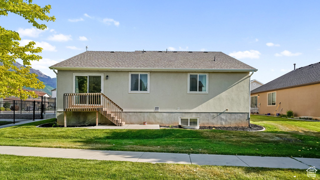 Rear view of property with stucco siding, a shingled roof, and cooling unit