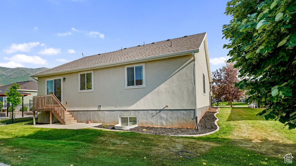 Rear view of house featuring stucco siding and a mountain view