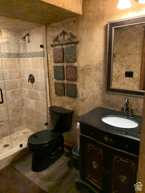 Bathroom featuring a shower stall and vanity