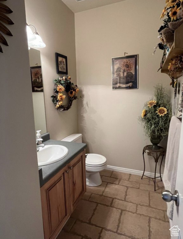 Half bathroom with toilet and vanity