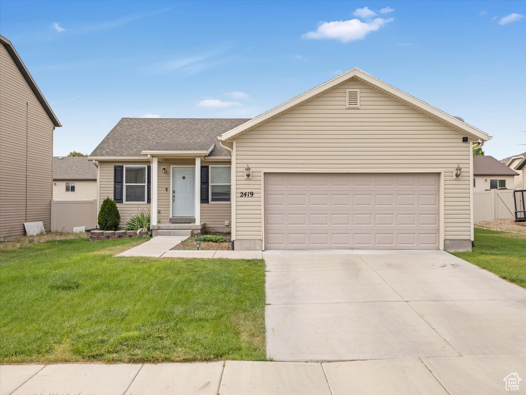 Ranch-style home with concrete driveway and an attached garage