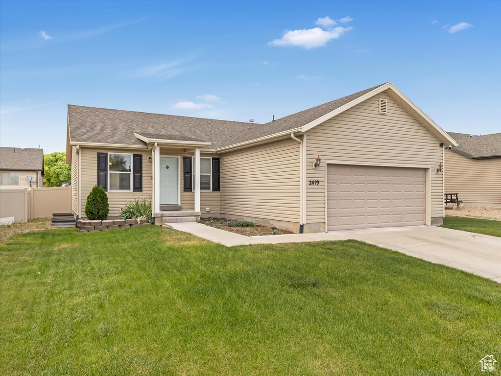 Ranch-style house with an attached garage, driveway, and roof with shingles
