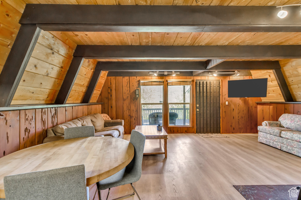 Living area with wood walls, wood finished floors, and wood ceiling
