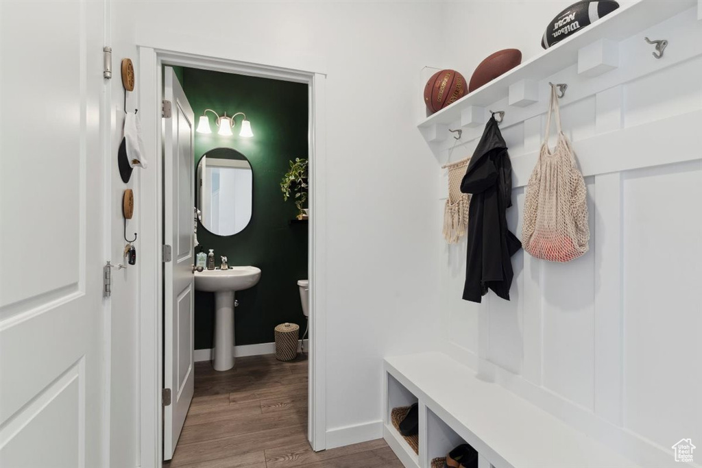 Mudroom with light wood-style flooring and baseboards