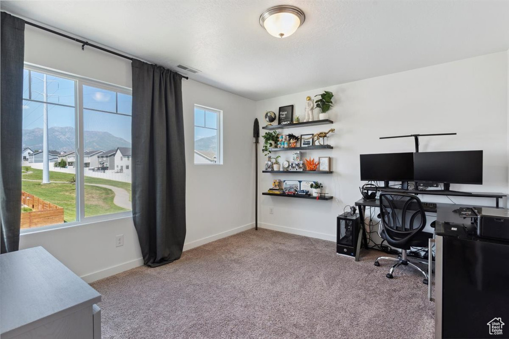 Office area featuring healthy amount of natural light, carpet flooring, and a mountain view