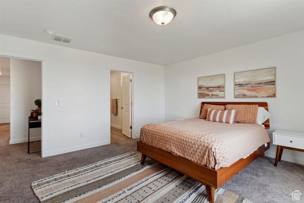 Carpeted bedroom featuring baseboards
