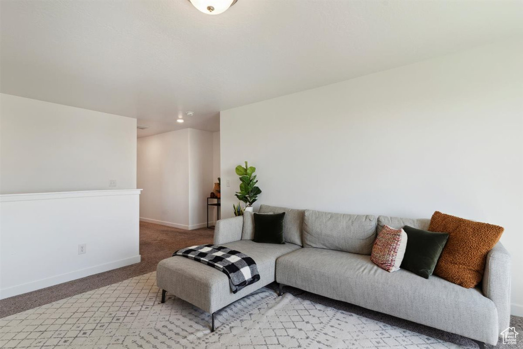 Living room with light colored carpet and baseboards
