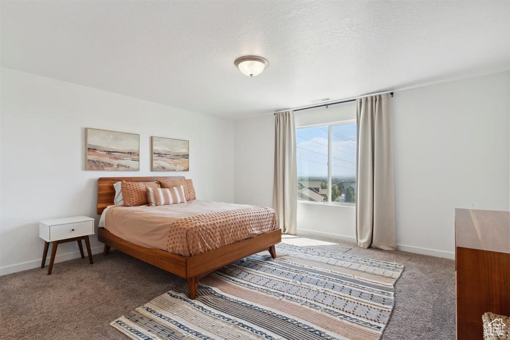 Bedroom with carpet and baseboards