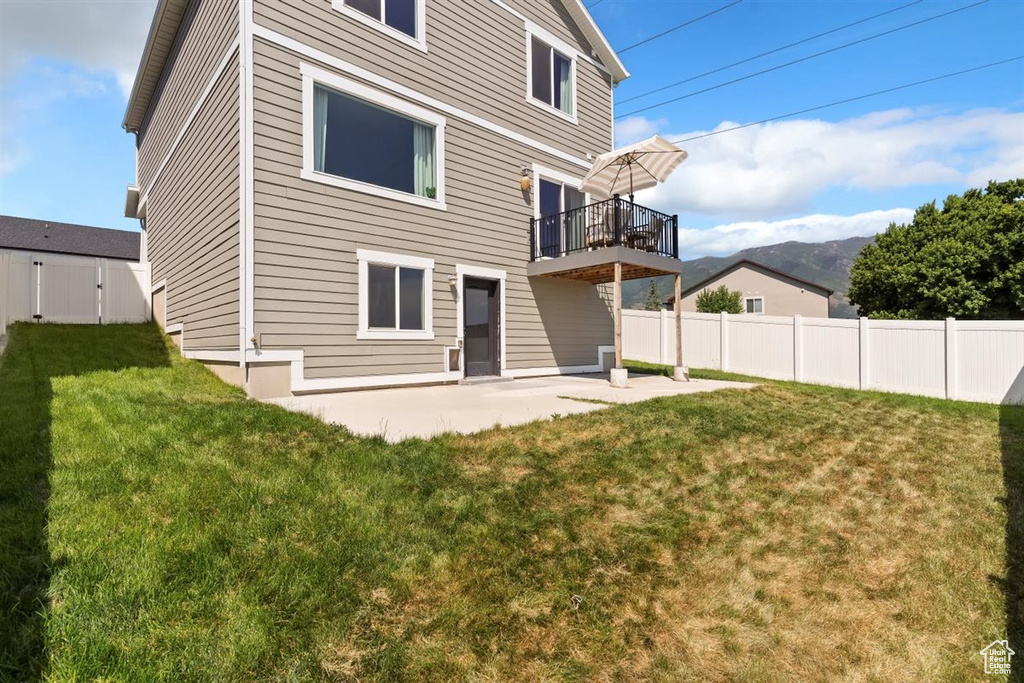 Rear view of house with a patio area and a mountain view