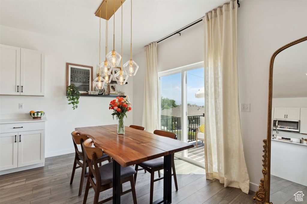 Dining space featuring dark wood-style floors