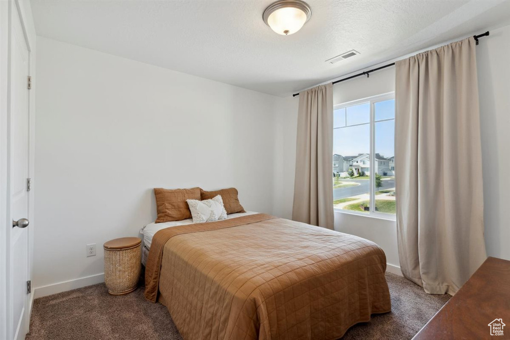 Bedroom featuring carpet flooring and baseboards