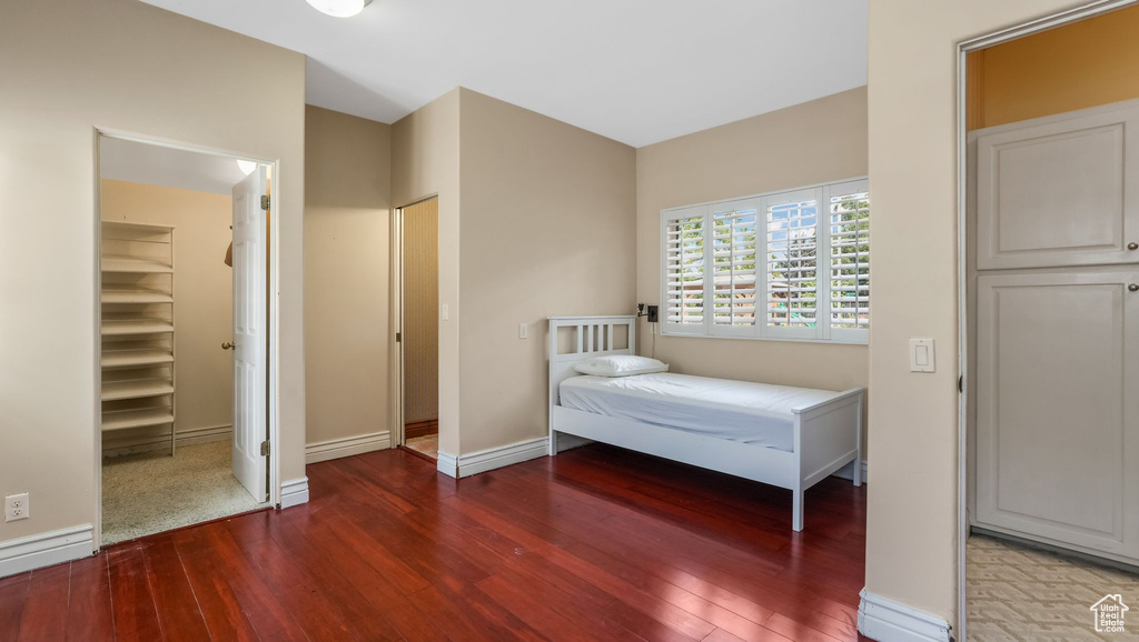 Bedroom with wood-type flooring and baseboards