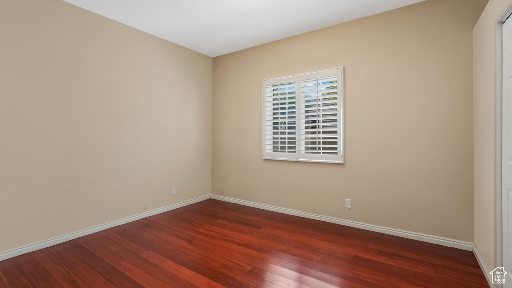 Unfurnished room featuring dark wood finished floors