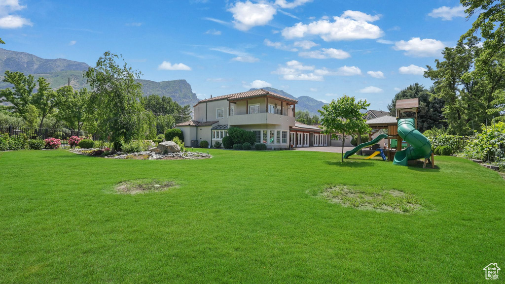 View of grassy yard with a mountain view