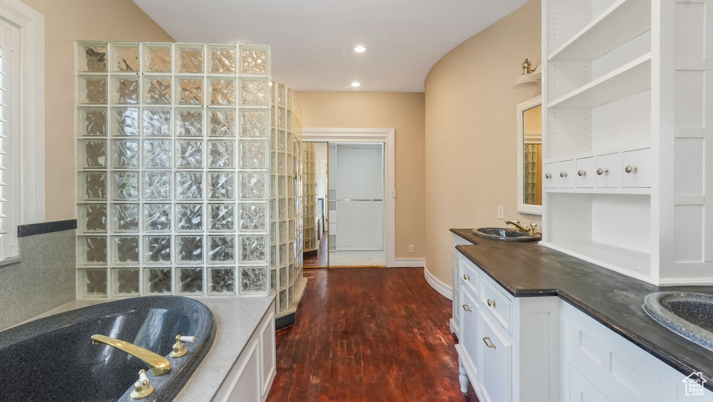 Kitchen with dark wood-style floors, white cabinetry, open shelves, recessed lighting, and glass insert cabinets