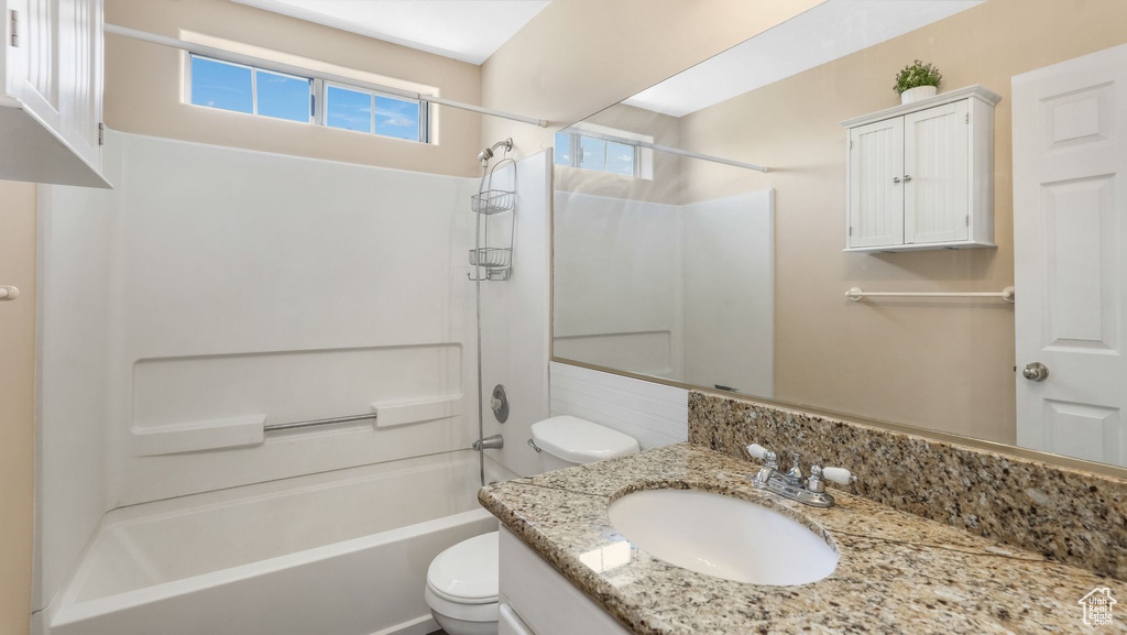 Bathroom with vanity and shower / washtub combination