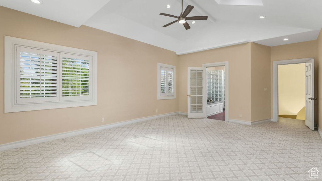 Carpeted spare room featuring a ceiling fan, recessed lighting, and lofted ceiling