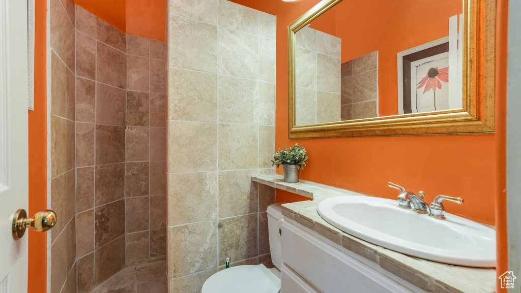 Bathroom with vanity and tiled shower