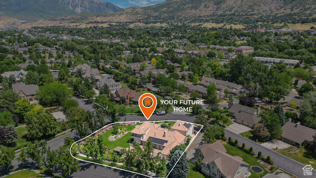 Aerial view of property and surrounding area featuring property parcel outlined and nearby suburban area