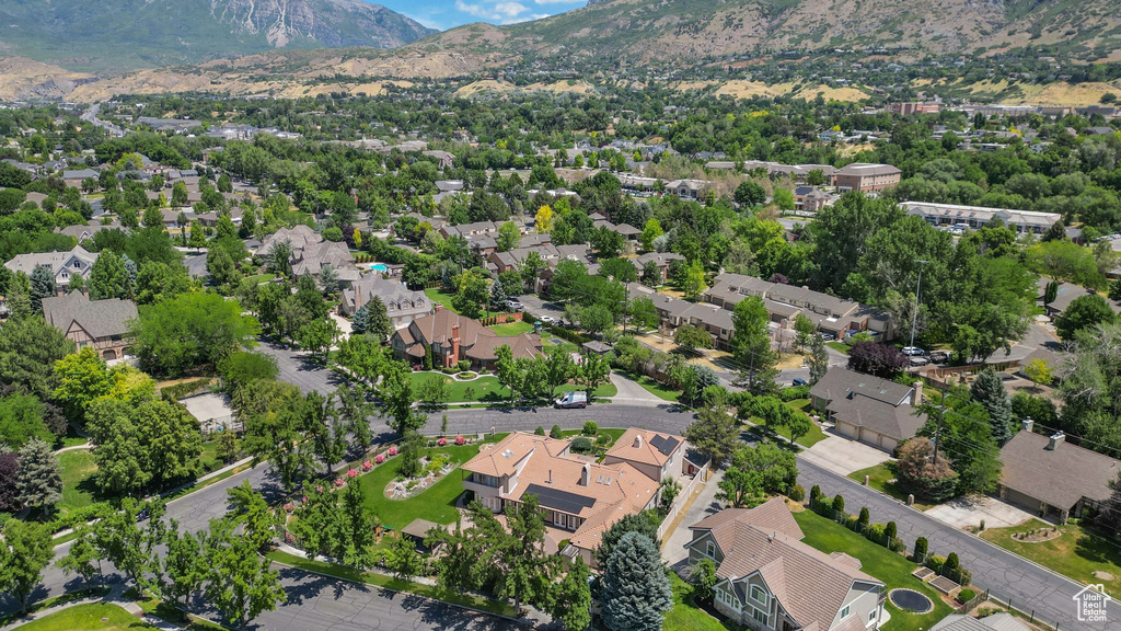 Aerial overview of property's location with a mountain backdrop and nearby suburban area